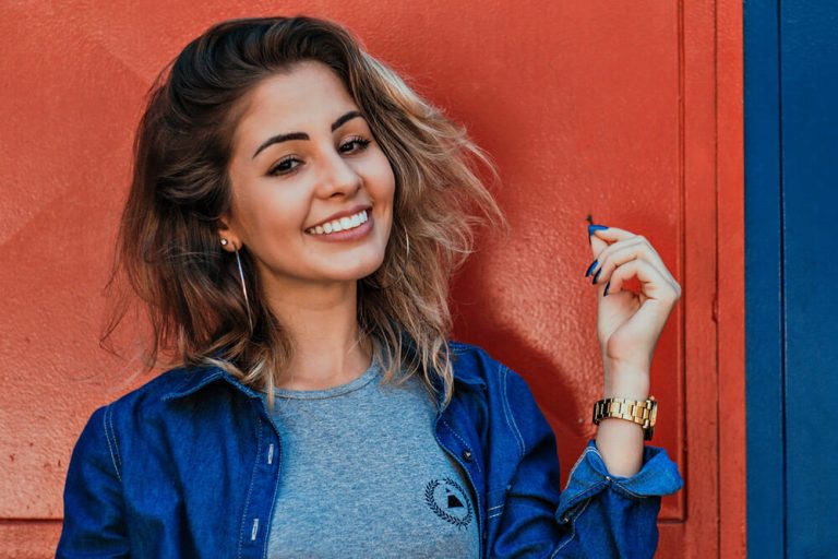Portrait of a young woman smiling to show off her dental veneers