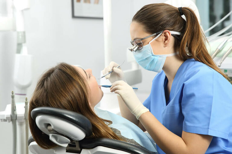 dentist looking in patients mouth